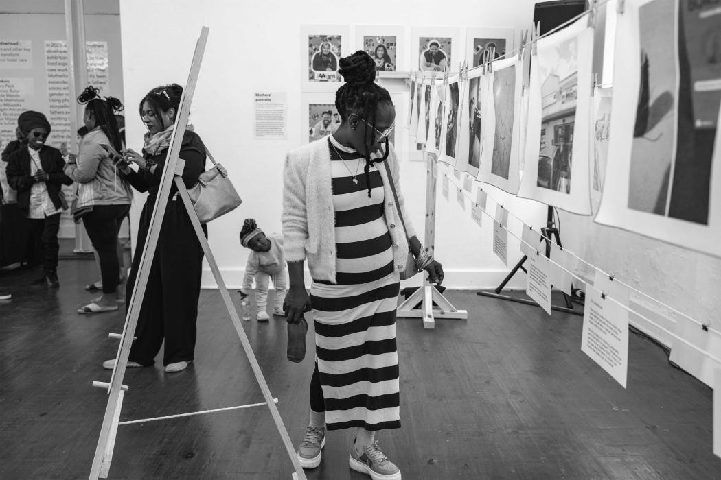 A visitor is taking in the powerful images and stories shared by mothers.