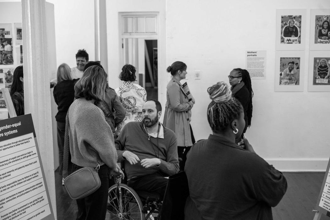 visitors at exhibition engaged in conversation 