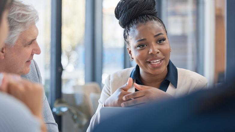 Women in office meeting in discussion with team