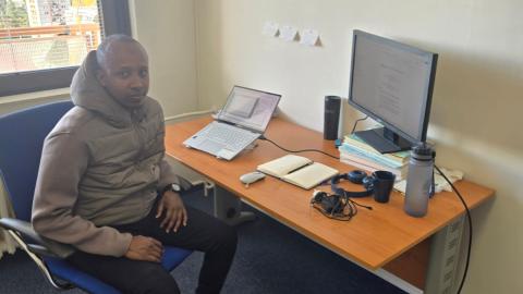 Abdiaziz at Charles University in his office