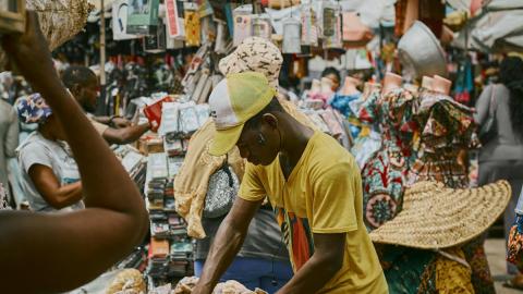Man selling goods at a market in an African city