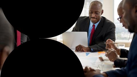 Meeting of team of executives at office table