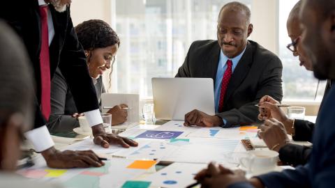 Meeting of team of executives at office table