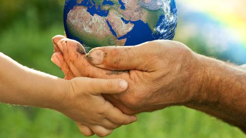 Two hands holding the earth