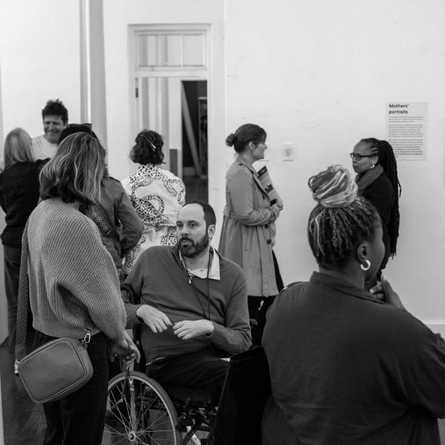 visitors at exhibition engaged in conversation 