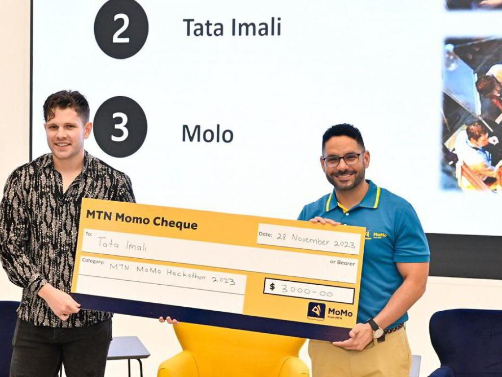 Gregory Andrews (left), CEO and founder of Tata-iMali, collects the second prize in the MTN MoMo Hackathon 2023 on behalf of his team.