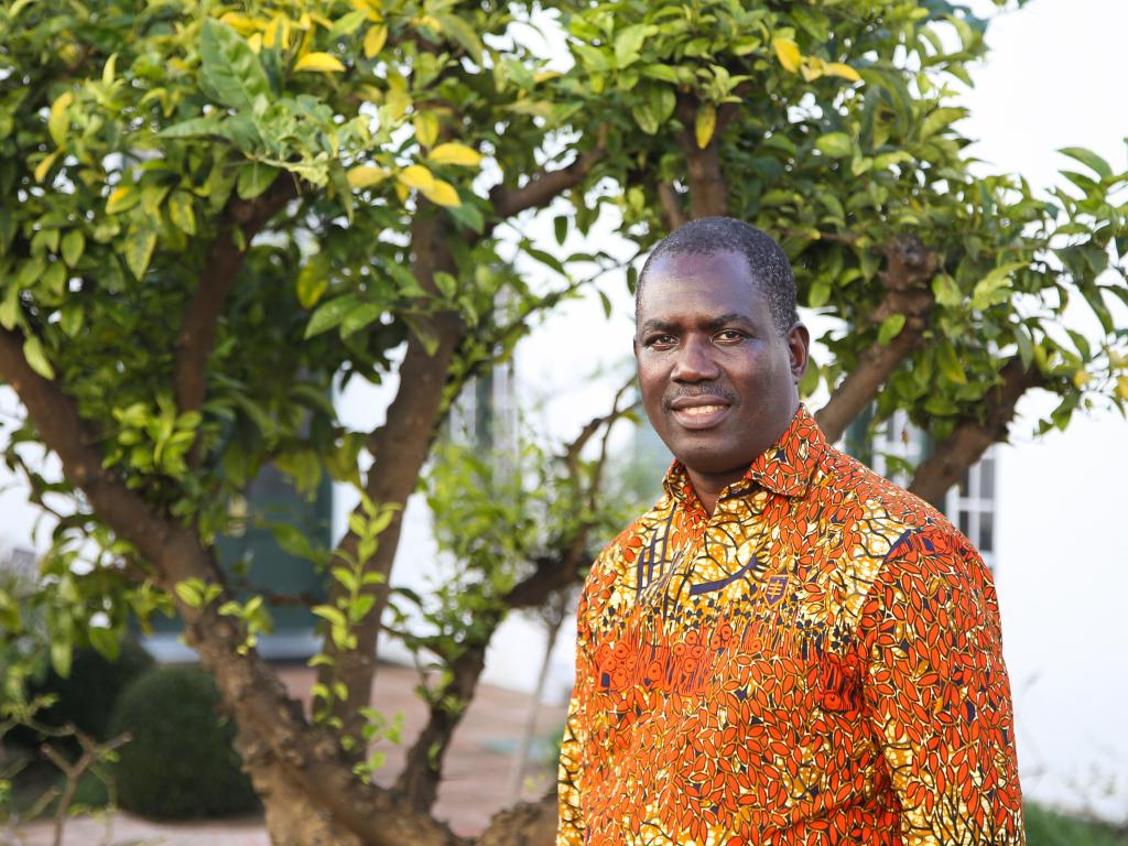 Edwin Muchapondwa smiling with a tree in the background