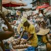 Man selling goods at a market in an African city